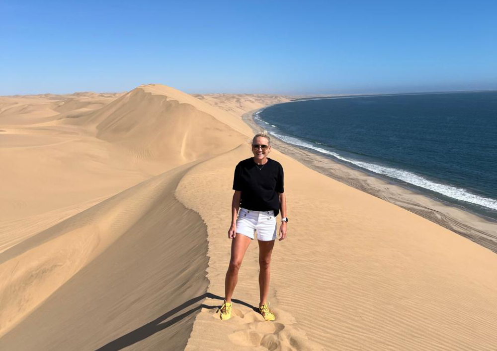 African Safari Consultants, consultant, Camill Rowe standing on top of due in Sossusvlei, Namibia. 